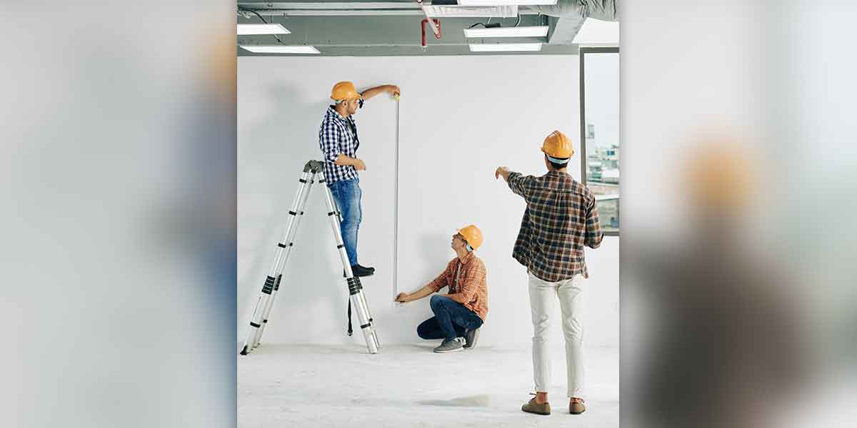 construction workers integrators installers measuring a space